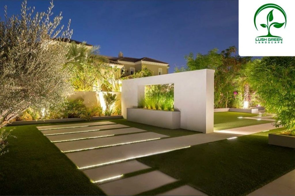 Illuminated garden steps and architectural planting at dusk